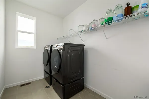 a view of a storage & utility room with windows