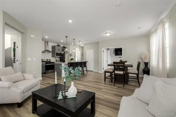 a living room with furniture and kitchen view