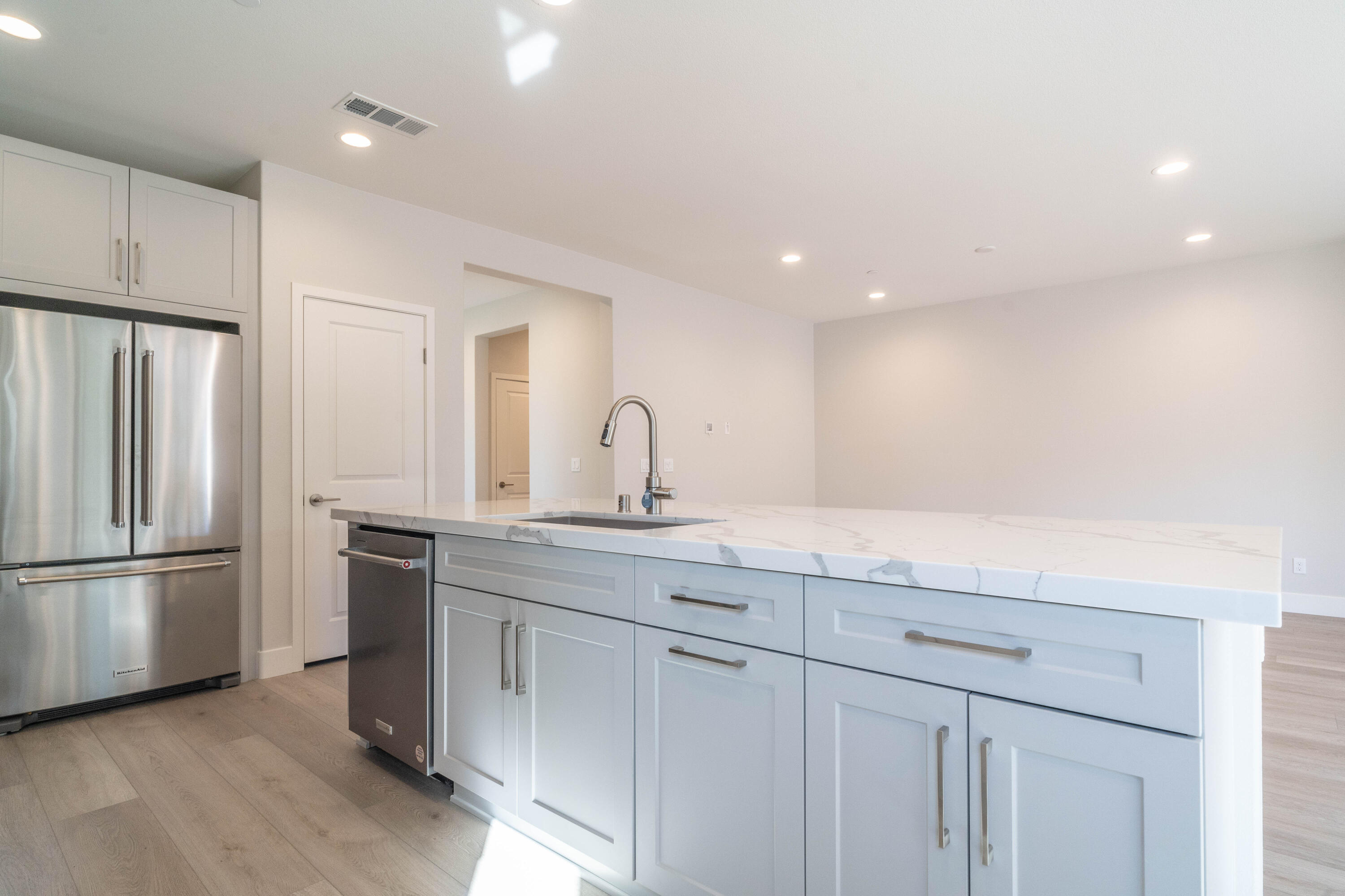 51580 Whiptail Drive Indio, CA 92201 - Photo 9 of 28 a kitchen with white cabinets and stainless steel appliances