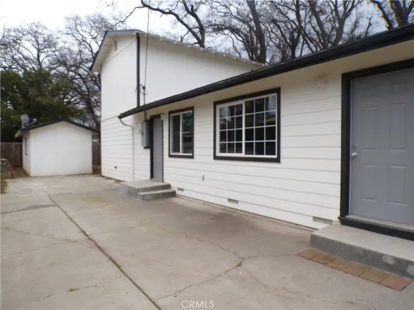 a view of house with yard and garage