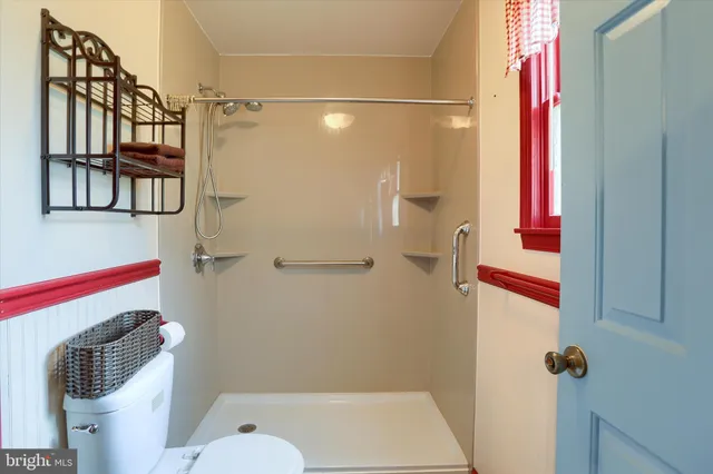 a bathroom with a shower toilet and sink