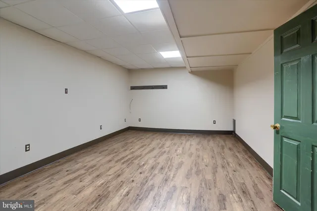 a view of a room with wooden floor and a window