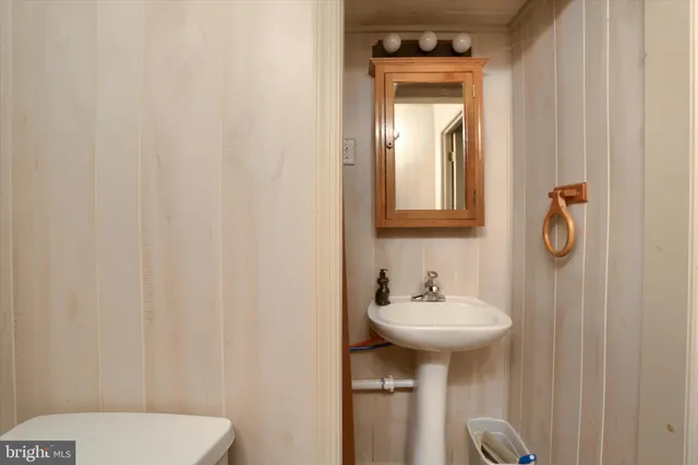a bathroom with a sink a mirror and a toilet