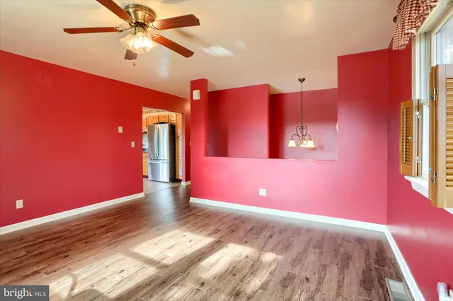 a view of a livingroom with a ceiling fan and window