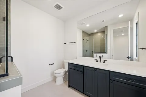 a bathroom with a tub sink a mirror and a shower