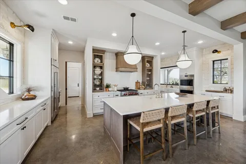 a large kitchen with a table and chairs