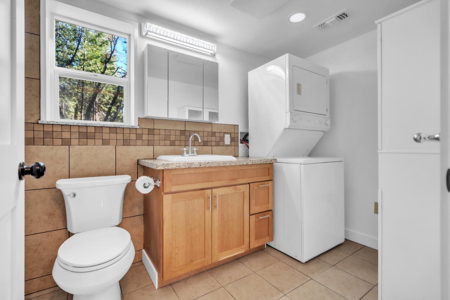 740 Hideaway Loop Alta, CA 95701 - Photo 16 of 74 a bathroom with a toilet sink and mirror