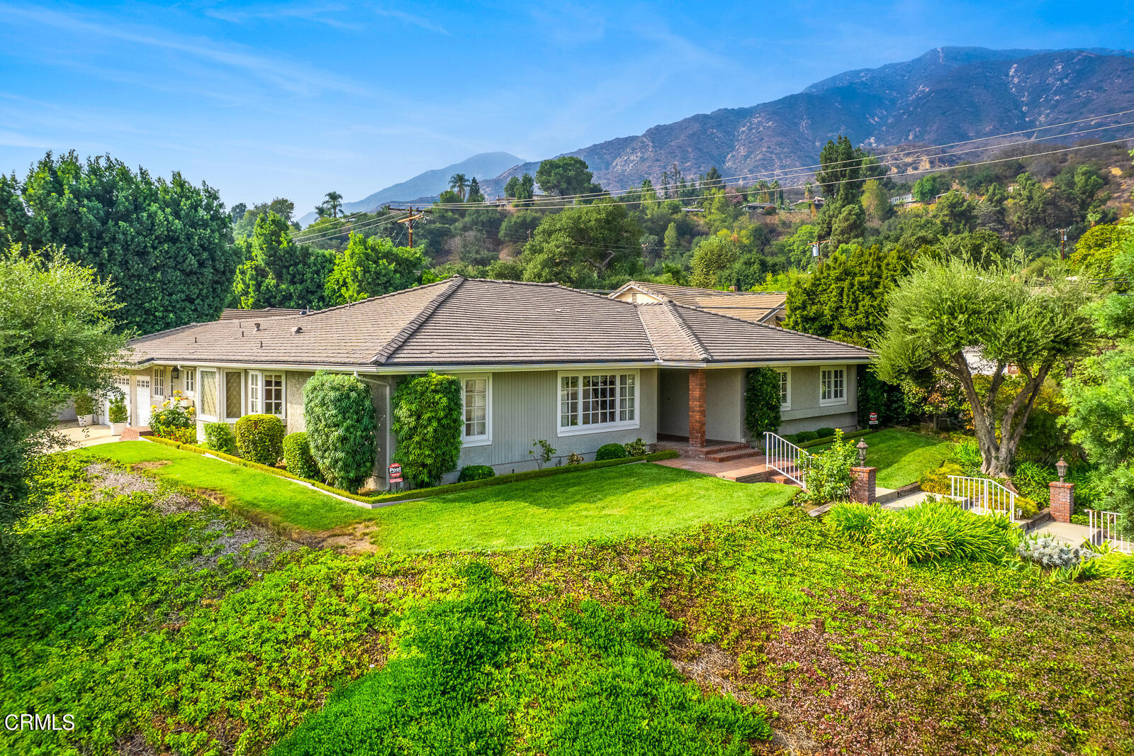 a view of a house with garden and a sitting area
