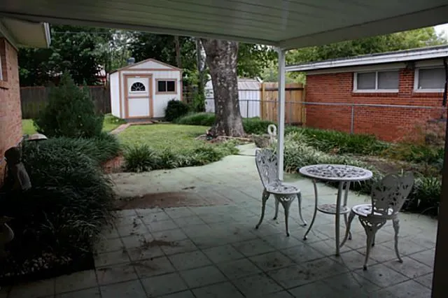 a view of a chairs and table in backyard of the house