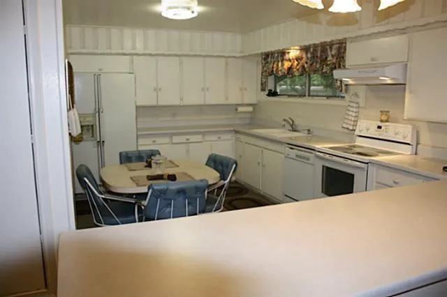 a kitchen with stainless steel appliances a sink a stove and a refrigerator