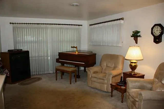 a living room with furniture and a lamp