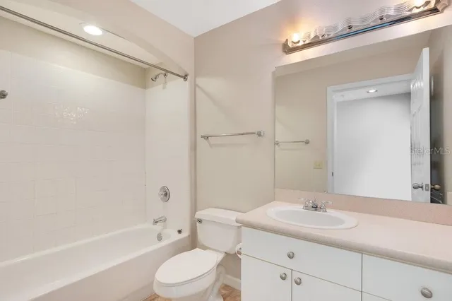 a bedroom with a large window and a balcony