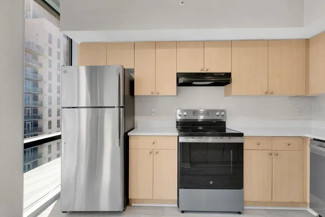 a kitchen with a refrigerator and a stove