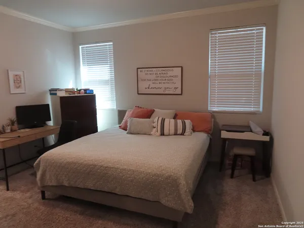 a bedroom with a bed and a desk