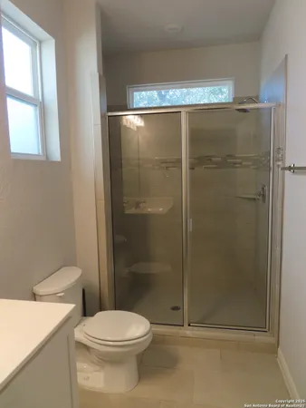 a bathroom with a toilet and a shower
