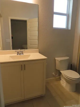 a bathroom with a sink toilet and mirror