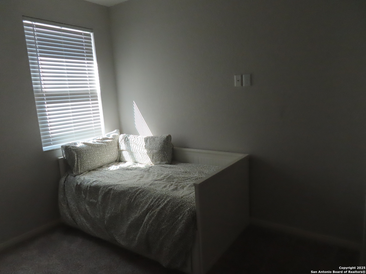 22150 Approach San Antonio, TX 78261 - Photo 2 of 18 a bedroom with a bed and a window