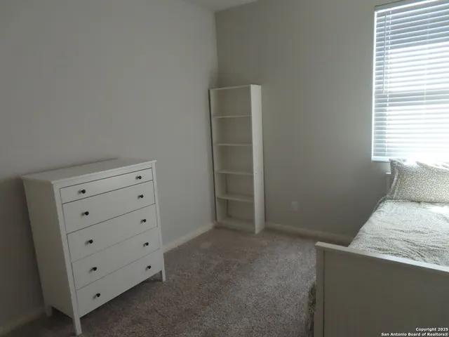 a room with a dresser and a window
