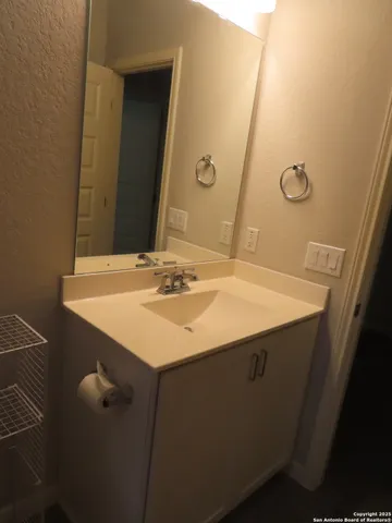 a bathroom with a sink vanity and a mirror
