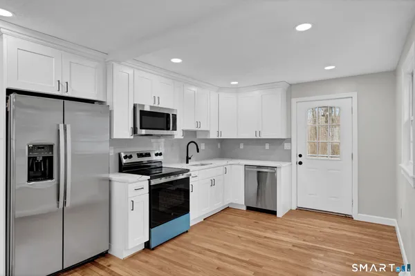 a kitchen with a stove a sink and a refrigerator