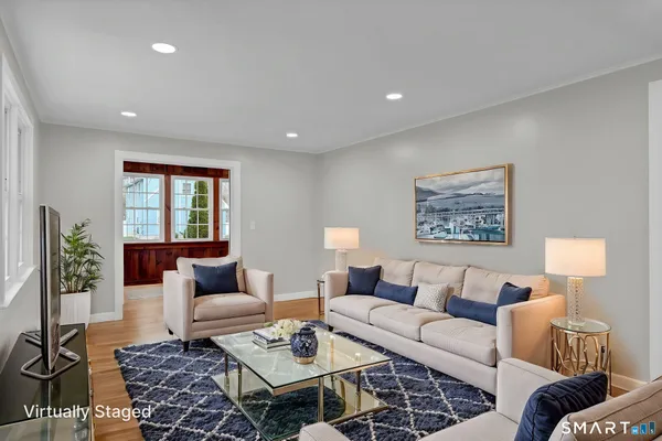 a living room with furniture or couch and a potted plant