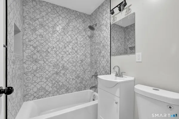 a bathroom with a sink a toilet and a bathtub