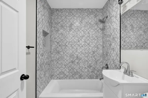 a bathroom with a shower and a sink