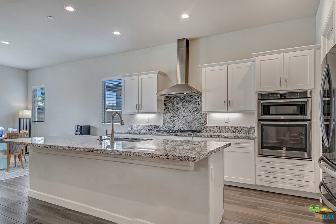 18 Riesling Rancho Mirage, CA 92270 - Photo 1 of 24 a kitchen with kitchen island granite countertop a stove and a sink