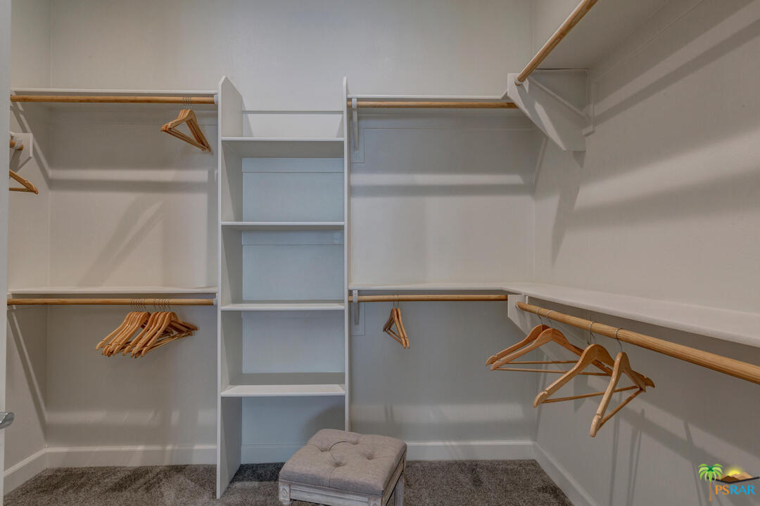 18 Riesling Rancho Mirage, CA 92270 - Photo 11 of 24 a view of walk in closet with clothes and shoes
