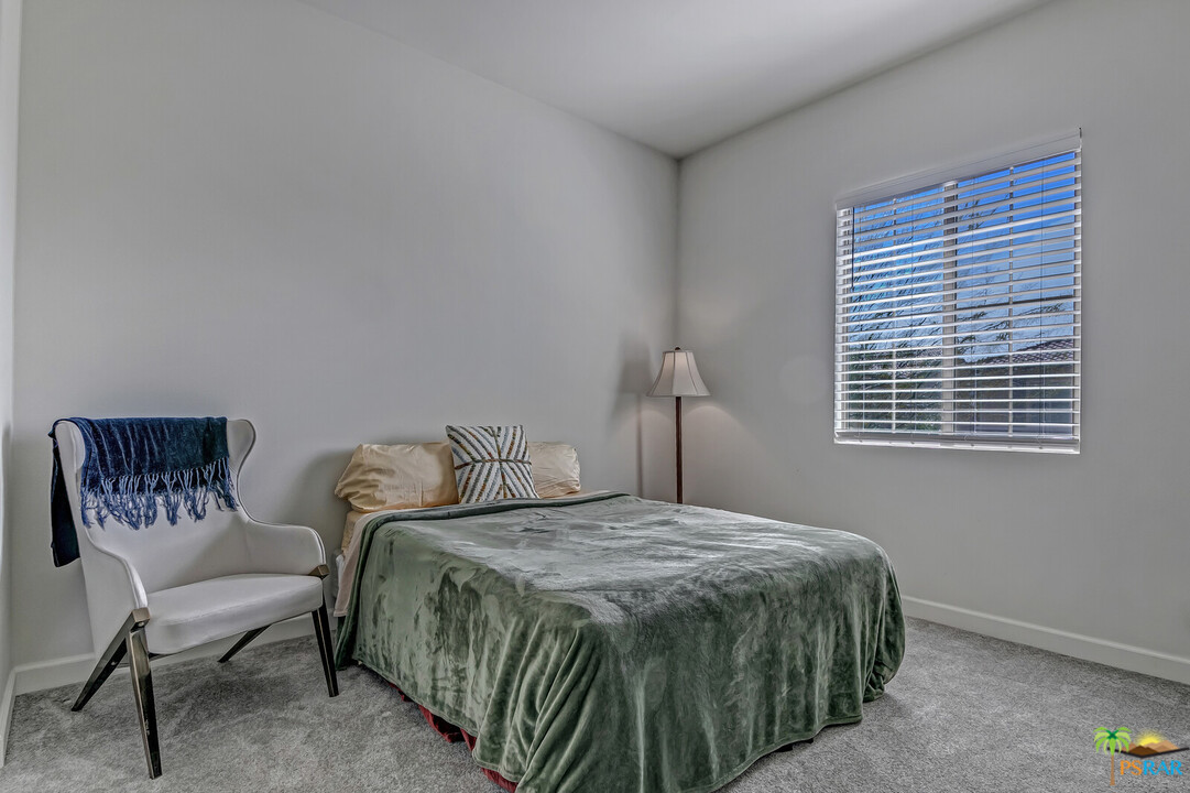 18 Riesling Rancho Mirage, CA 92270 - Photo 12 of 24 a bedroom with a bed and a chair