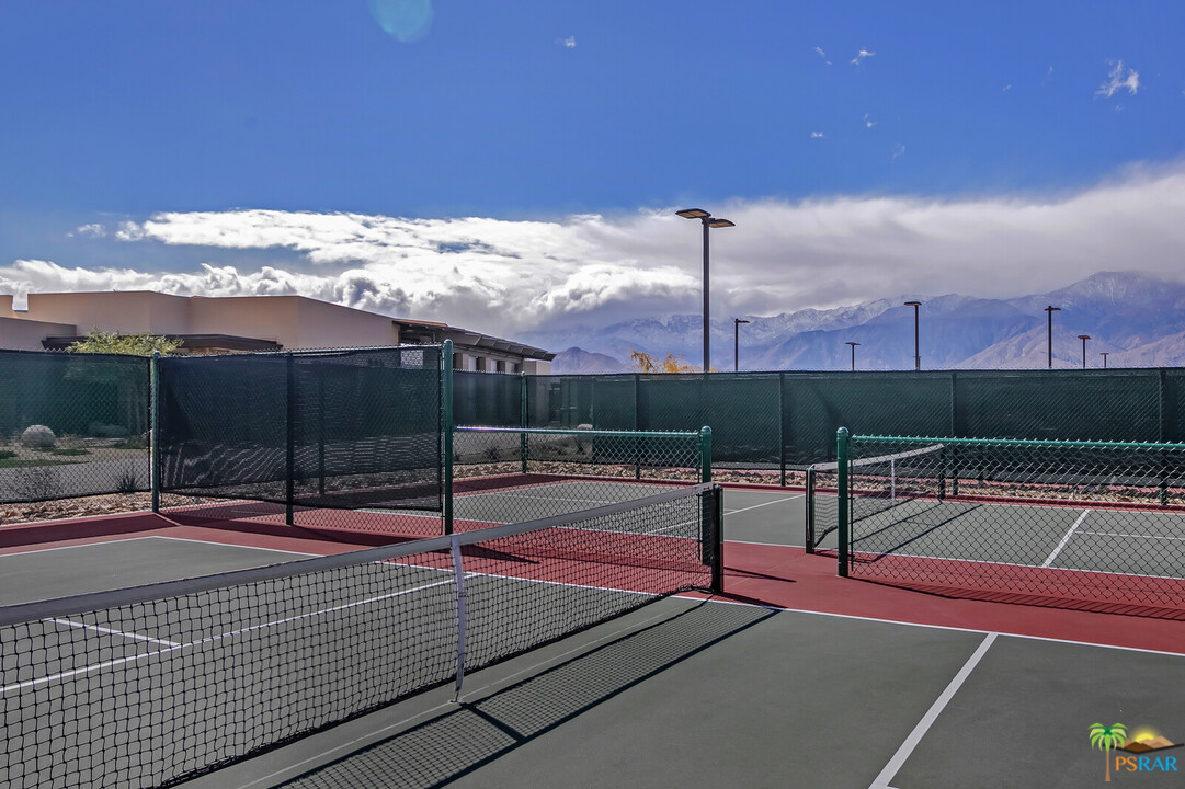 18 Riesling Rancho Mirage, CA 92270 - Photo 23 of 24 a view of a tennis court with lots of palm trees in the background