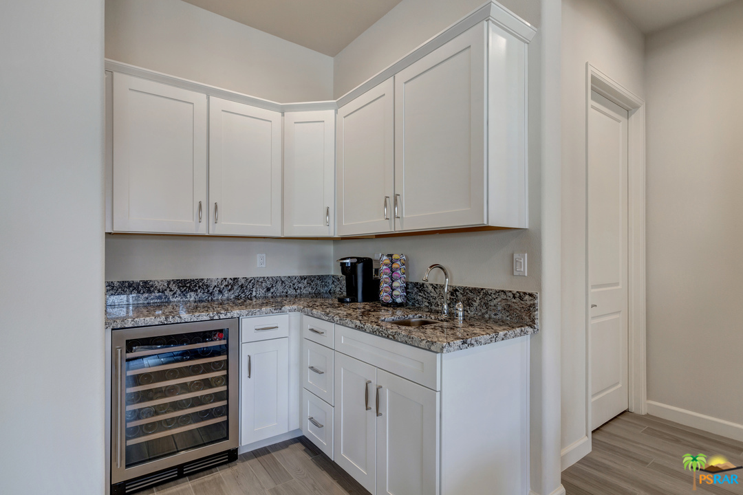 18 Riesling Rancho Mirage, CA 92270 - Photo 4 of 24 a kitchen with stainless steel appliances granite countertop white cabinets and sink