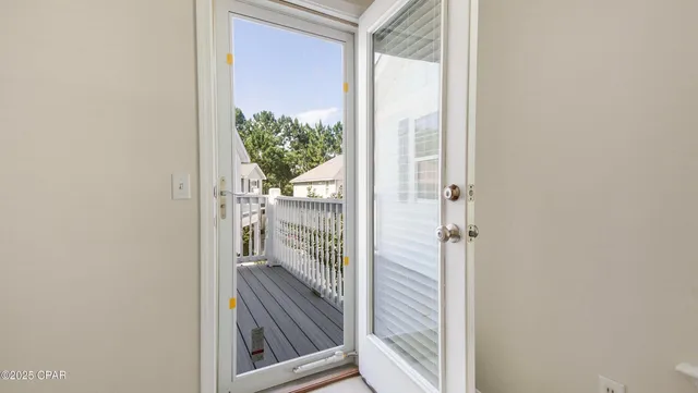 an empty room with closet and a ceiling fan