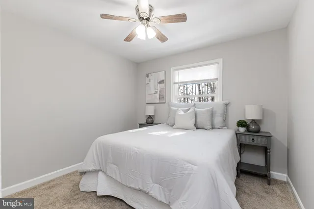 a spacious bedroom with a bed and window