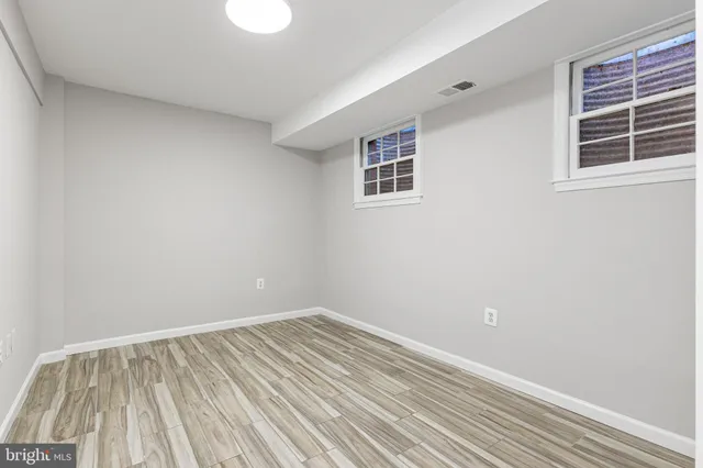 a view of an empty room and wooden floor