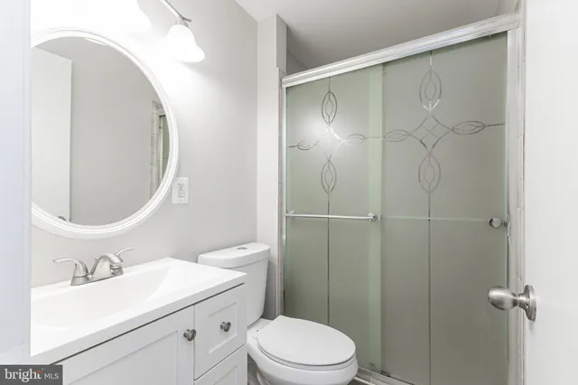 a view of a hallway with wooden floor and a fireplace