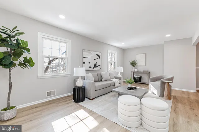 a living room with fireplace furniture and a window