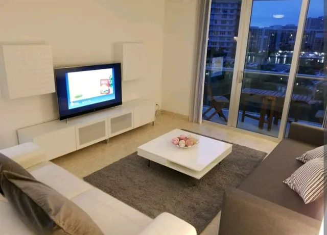 a living room with furniture and a flat screen tv