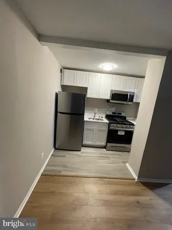 a kitchen with a stove and a refrigerator