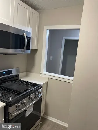 a stove top oven sitting inside of a kitchen