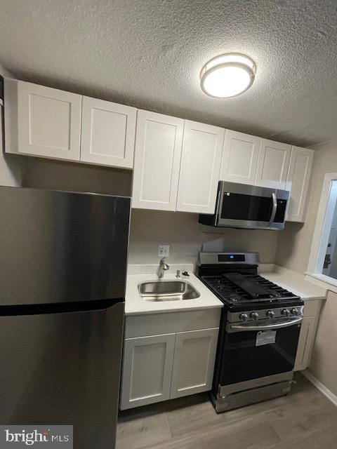 1836 Metzerott Road, Unit 1516 Hyattsville, MD 20783 - Photo 19 of 26 a kitchen with stainless steel appliances a refrigerator stove and microwave