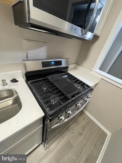 1836 Metzerott Road, Unit 1516 Hyattsville, MD 20783 - Photo 22 of 26 a close up of a stove top oven sitting inside of a kitchen