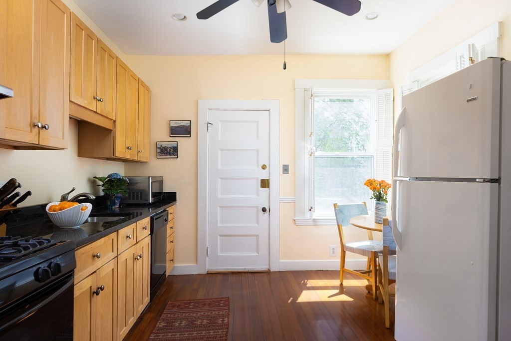 42 Stanton Road, Unit 1 Brookline, MA 02445 - Photo 6 of 16 a kitchen with stainless steel appliances a refrigerator a stove a microwave and cabinets