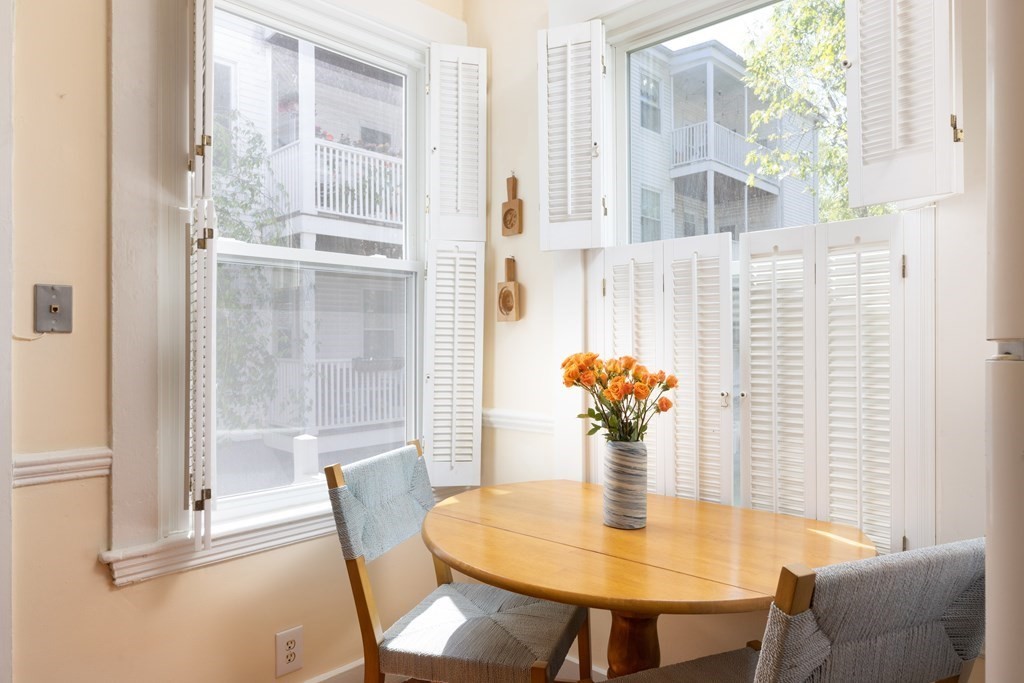 42 Stanton Road, Unit 1 Brookline, MA 02445 - Photo 7 of 16 a dining room with furniture and chandelier