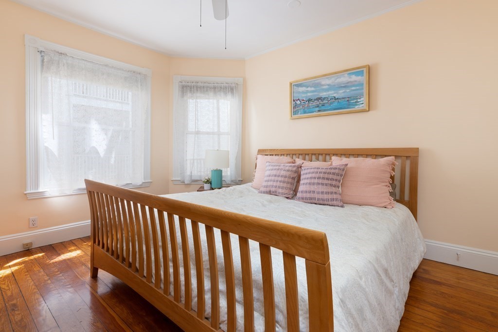 42 Stanton Road, Unit 1 Brookline, MA 02445 - Photo 8 of 16 a bedroom with a bed and wooden floor