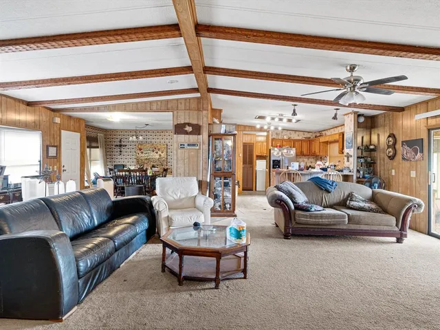 a kitchen with stainless steel appliances kitchen island granite countertop a refrigerator and cabinets