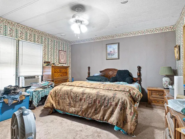 a bedroom with bed and window