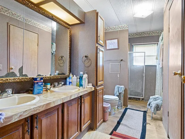 a bathroom with a sink toilet tub and shower