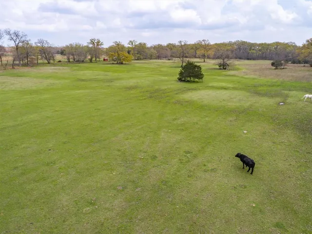a view of a house with wooden stairs and a table