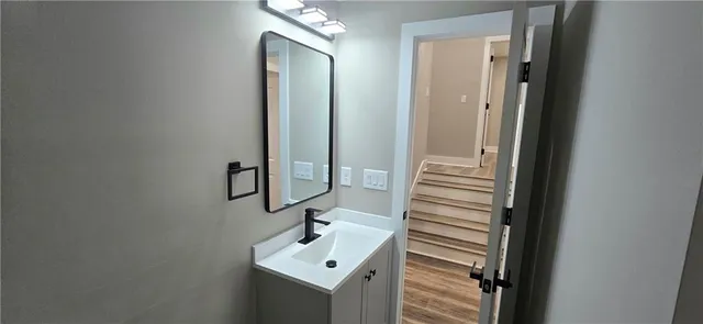 a bathroom with a sink a mirror and shower